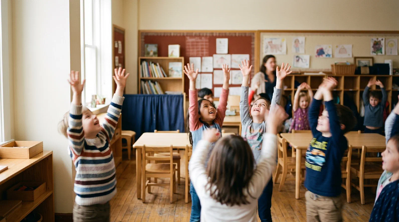 Children stretching arms up in a bright classroom during a movement break